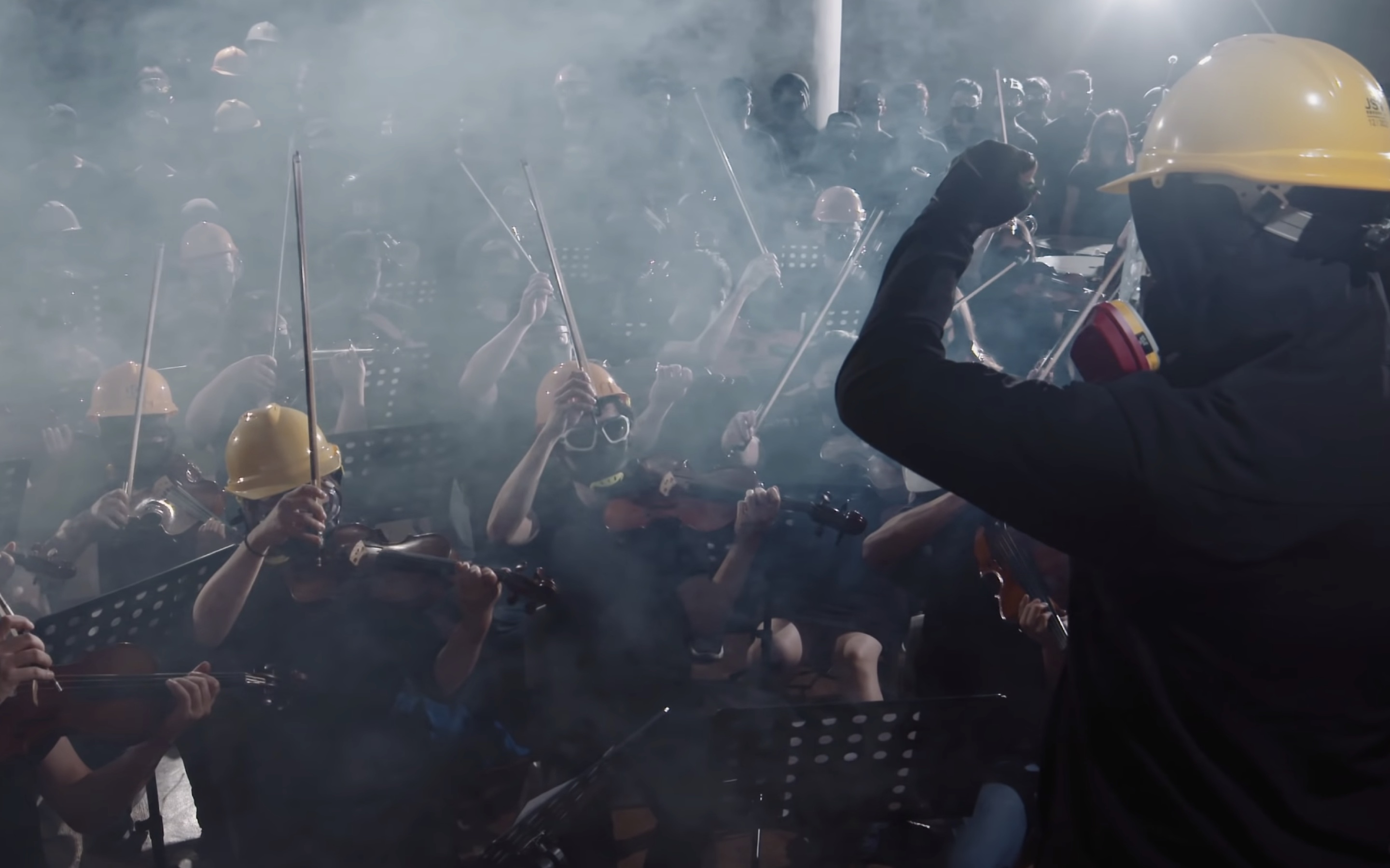 An orchestra and choir dressed in full protest gear perform in a music video for “Glory to Hong Kong,” a new anthem created for the protest movement. Screengrab via YouTube