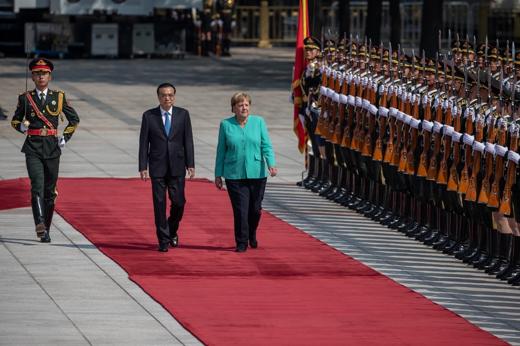 Chinese Premier Li Keqiang (center left) and German Chancellor Angela Merkel (center right) inspect an honor guard during a welcome ceremony at the Great Hall of the People in Beijing on September 6, 2019. Photo via AFP.