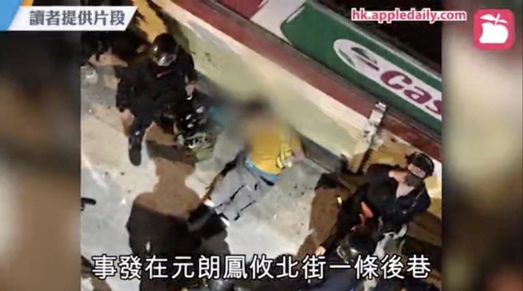 A 'Protect The Children' volunteer sitting unconscious in Yuen Long. Screengrab via Apple Daily video.