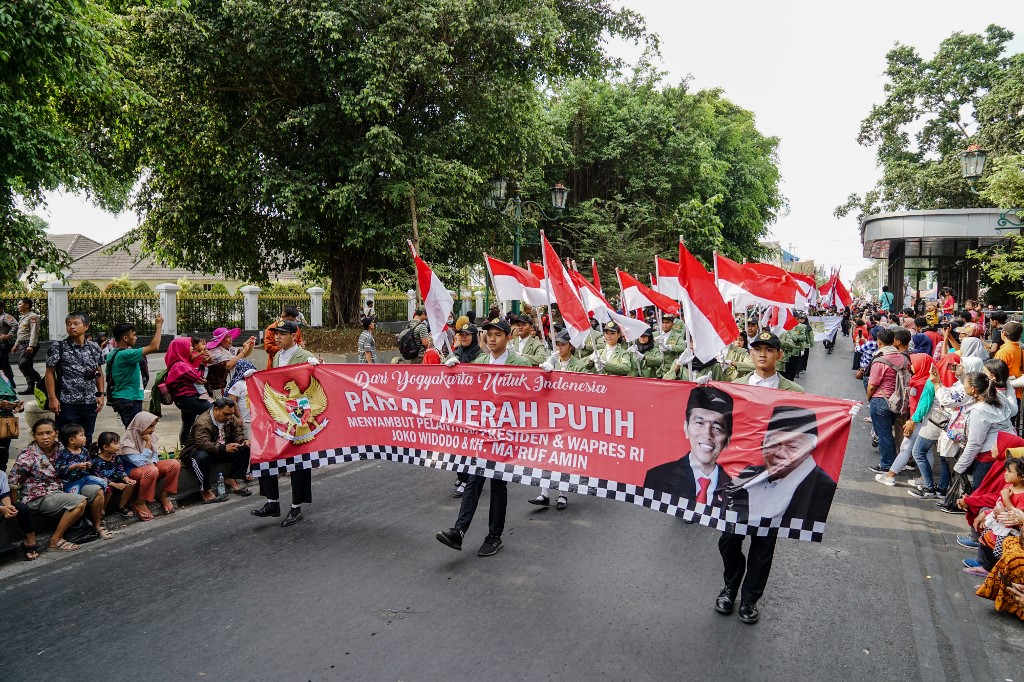 Indonesians take part in a parade to celebrate the upcoming inauguration of President Joko Widodo’s second term in Jakarta on October 19, 2019. (Photo by Oka HAMIED / AFP)
