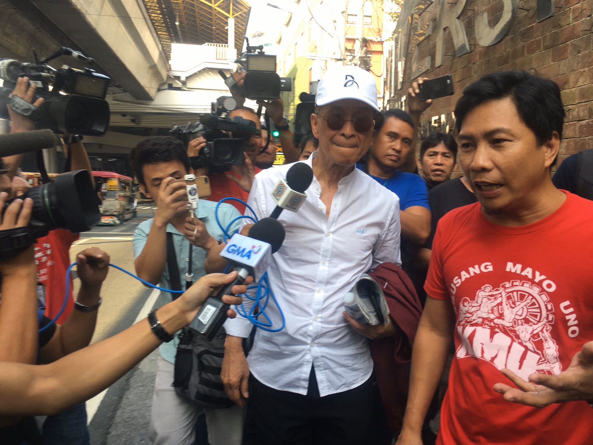 Reporters trail after Salvador Panelo as he takes public transportation this morning. <i></noscript>Photo: Jervis Manahan/ABS-CBN News</i>