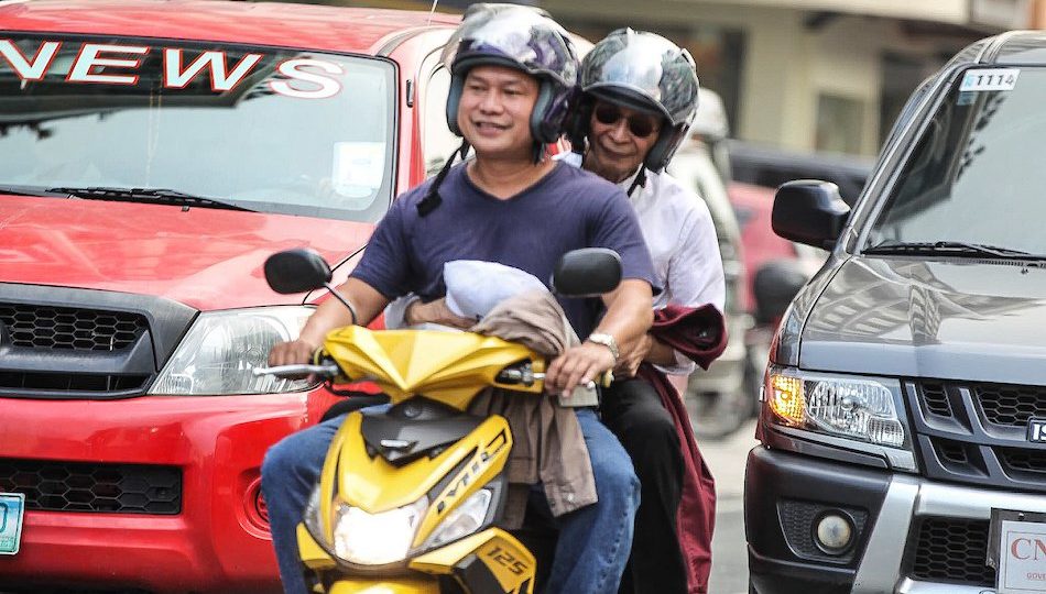 Salvador Panelo is given a free ride by a motorcyclist. <i></noscript>Photo: Jonathan Cellona/ABS-CBN News</i> 