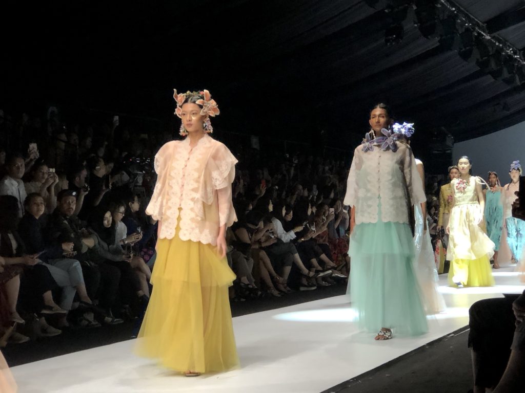 TOTON, founded by Makassar-born designer Toton Januar and Haryo Balitar, is a contemporary womenswear brand that’s inspired by Indonesia’s nature and diverse culture. Their Spring/Summer 2020 collection felt ethereal with variety of flowy materials such as lace and tulle in bright color palette, even with denim. Notable details are the kebaya-like design and scallop edges. The collection was presented in the Indonesia Fashion Forward Show on Friday, Oct 25. Photo by Nadia Vetta Hamid for Coconuts Media