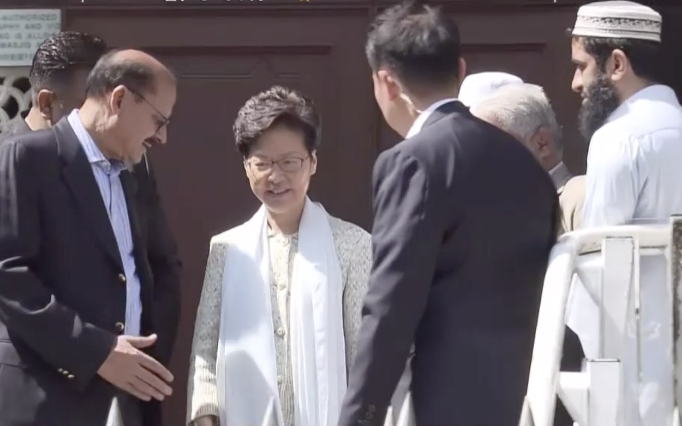 Carrie Lam leaving Kowloon Mosque after a chat with hief imam Muhammad Arshad. The visit comes one day after a police water cannon covered the mosque in blue dye. Screengrab via Facebook/Now TV News.