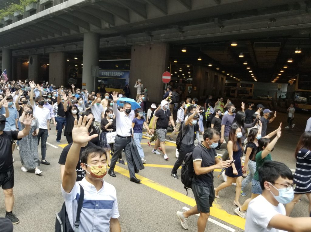 Hundreds walking through Central to protest a planned controversial anti-mask law. Photo by Vicky Wong.