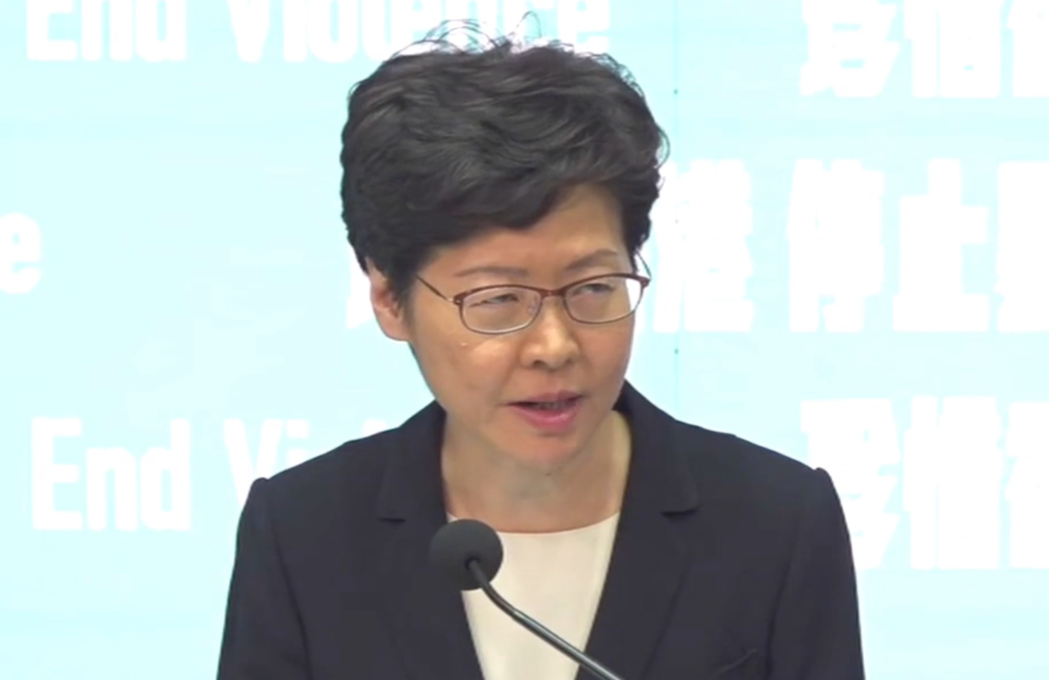 Chief Executive Carrie Lam announces the implementation of a controversial ban on face masks aimed at clamping down on protests at a press conference today. Screengrab via Facebook/HK01.
