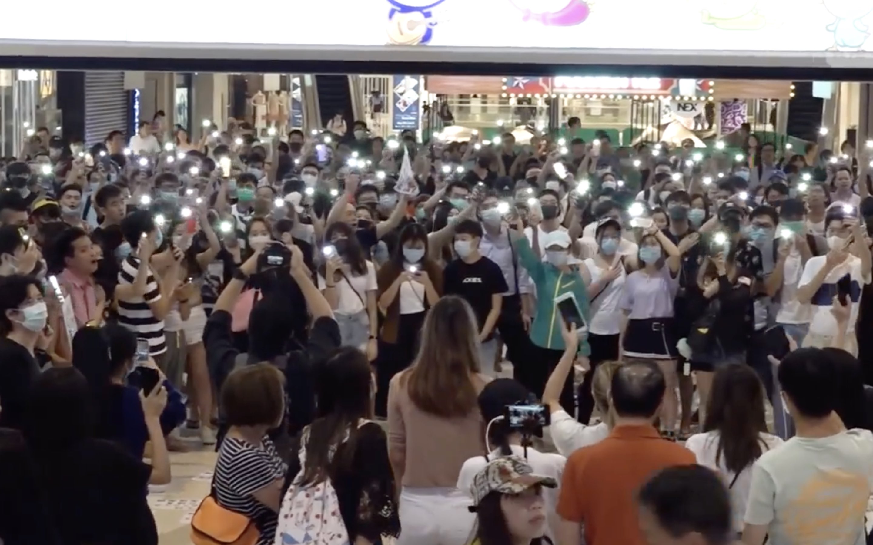 Protesters gather in MOSTown Mall in Ma On Shan in response to the arrest of five mall staff who tried to prevent riot police from charging into a mall. Screengrab via Facebook/RTHK video.