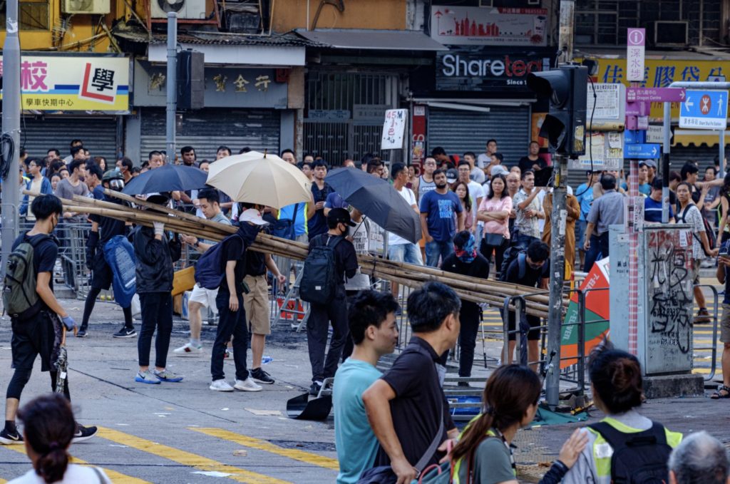 Protesters block roads in Sham Shui Po as surrounding shops are shuttered on Oct. 1, 2019. (Photo via Coconuts Media)