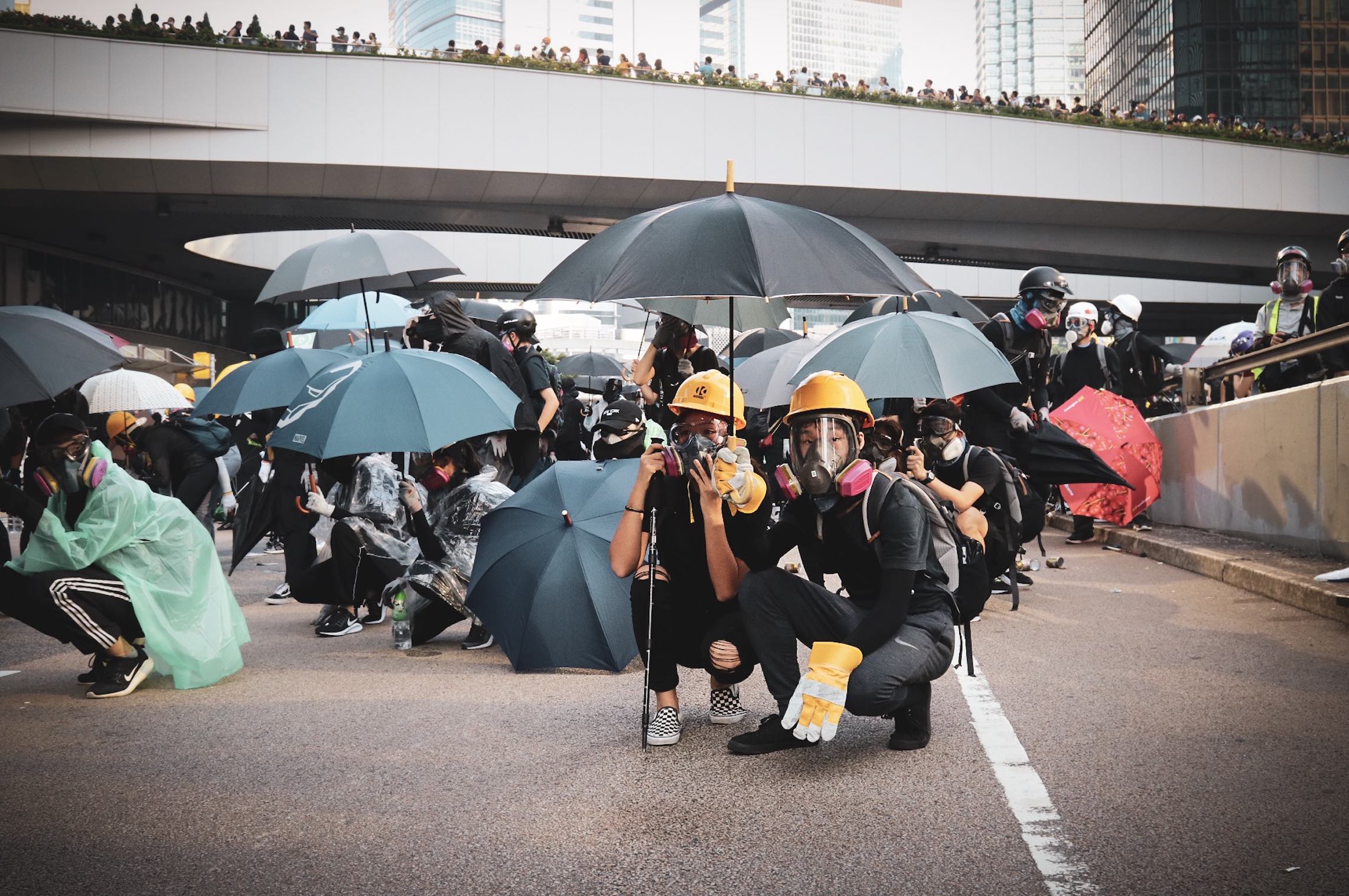 A young couple wait for the police response on Harcourt Road, shortly after water cannons were deployed in Admiralty. Photo by Samantha Mei Topp.