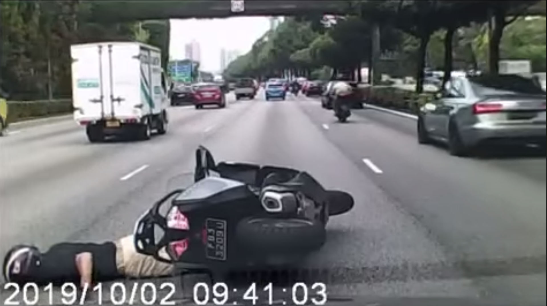Screenshot taken from All Singapore Stuff’s video showing the motorcyclist on the ground after the accident. All Singapore Stuff/Facebook