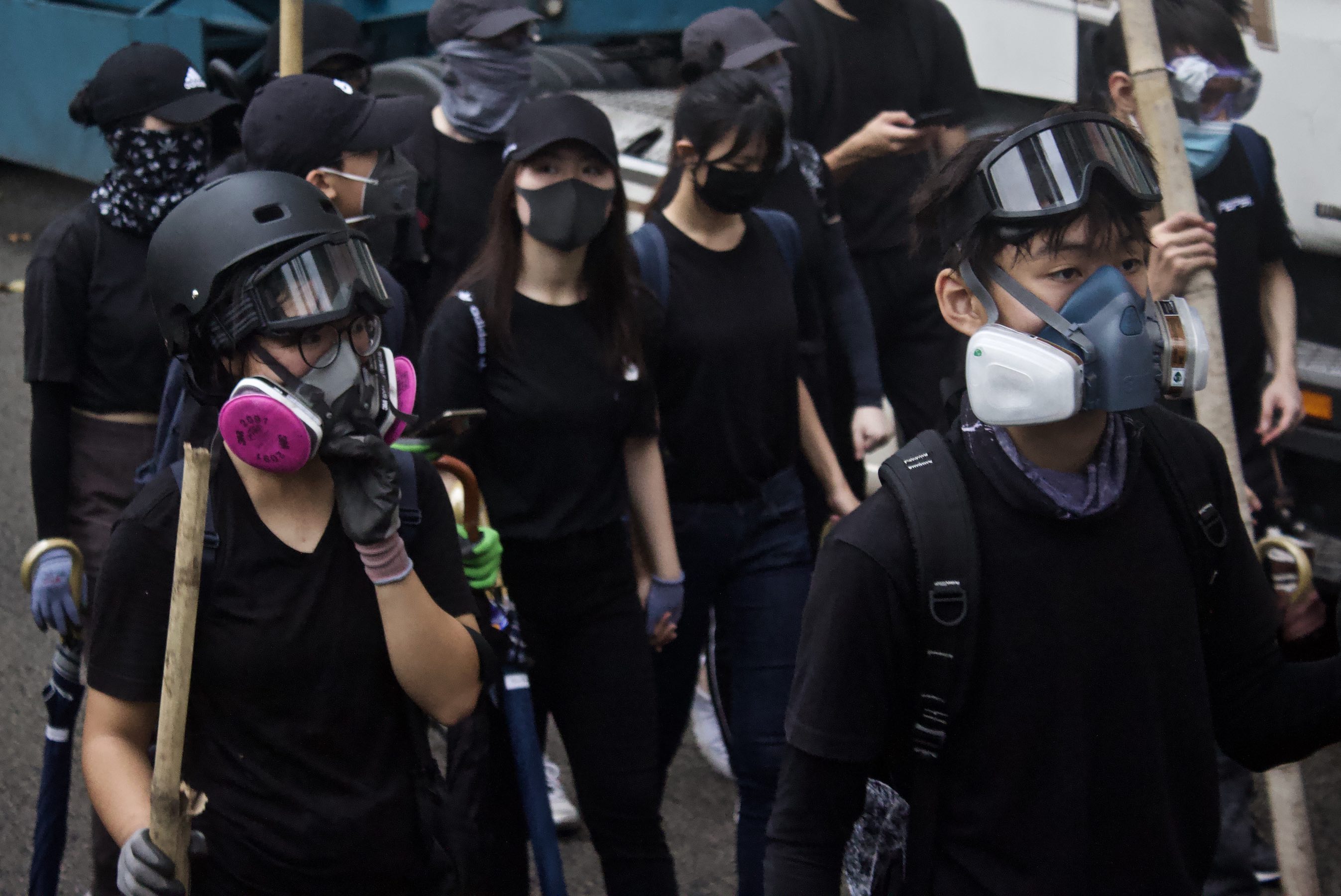 Masked protesters marching through Tai Kok Tsui in October. Photo by Vicky Wong.