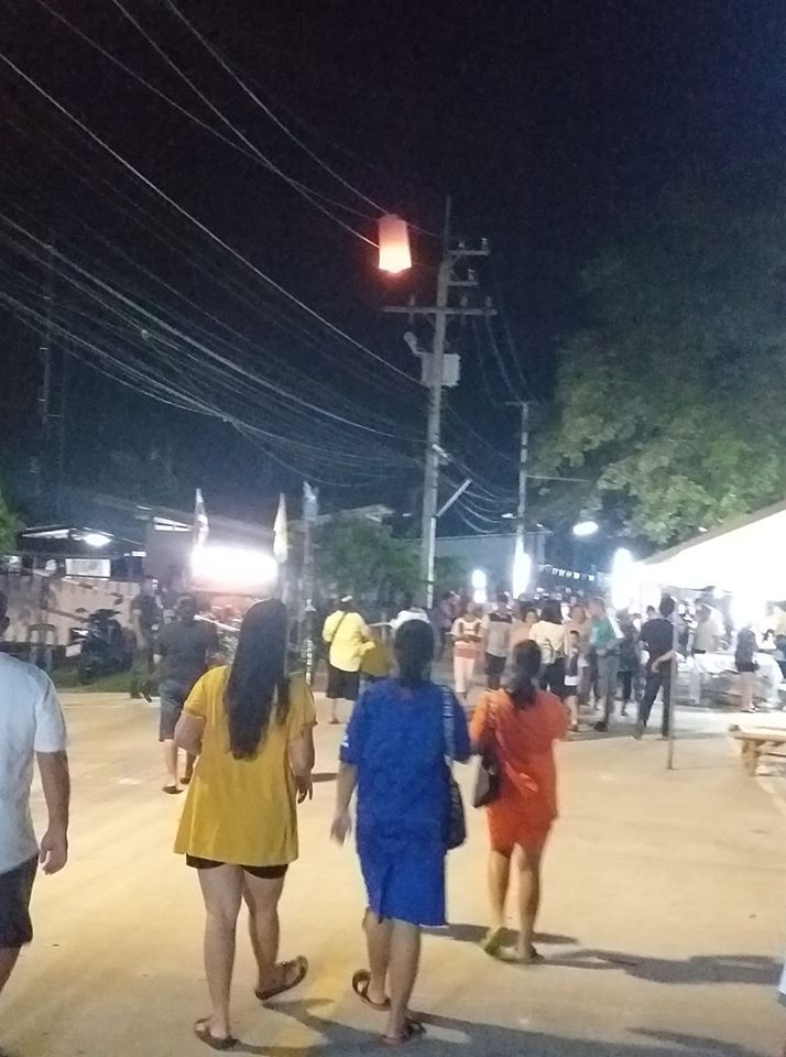 Twinkle, Sizzle, Little Star: Pedestrians marvel at a lantern stuck in some cables along a busy market street. Photo: Rodjanapohng Kumsaeng / Facebook