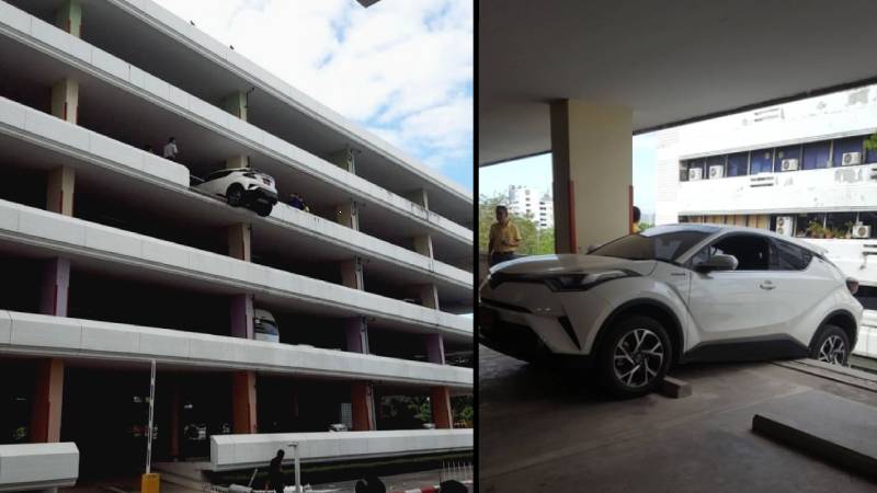 Ass Out: Rear end of a car dangles from the edge of the 4th floor of a parking structure at the Public Health Ministry in Nonthaburi province. Photo: JS100 