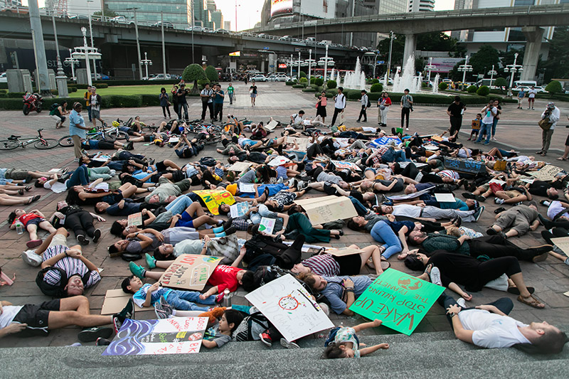 Climate Strike Thailand supporters join a 'die-in' late Friday afternoon at Bangkok's Lumphini Park. Photo: Joshua James