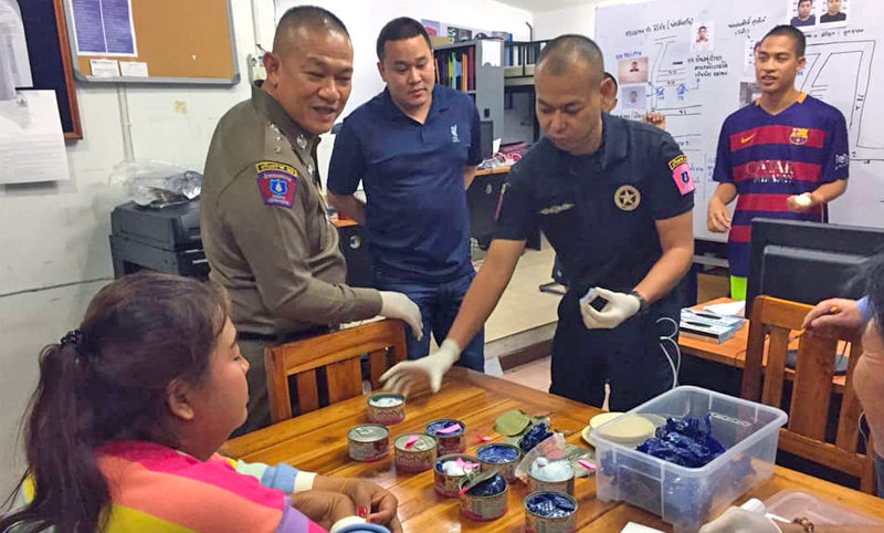 Police lay out the evidence of meth-filled sardine cans inside three suspects’ luggage Monday at Don Mueang Airport in Bangkok. Photo: Capital Detective / Facebook
