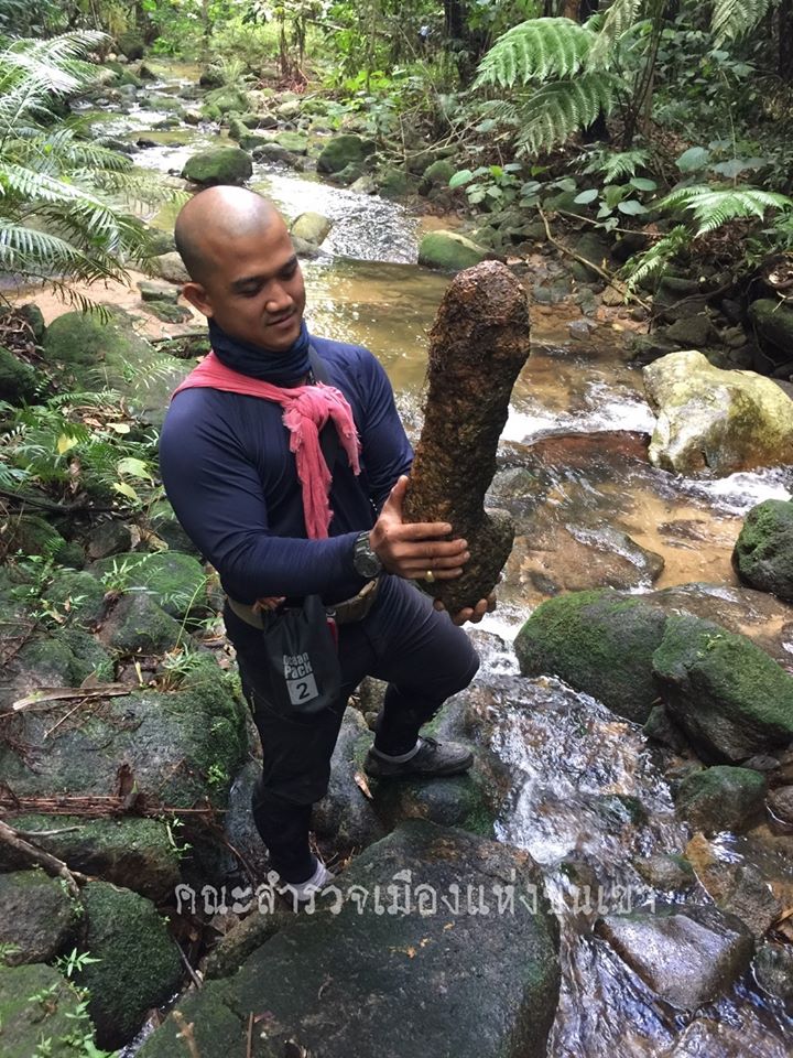 A member of Phum’s team displays a phallus-shaped rock discovered during the exploration. Photo: Phum Jiradejwong / FB