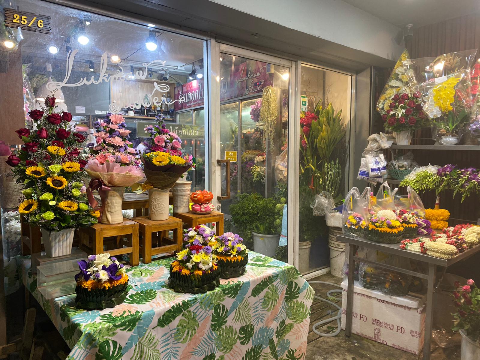 Nichapat Konchit’s flower shop was selling krathongs out front Monday evening. Photo: Coconuts 