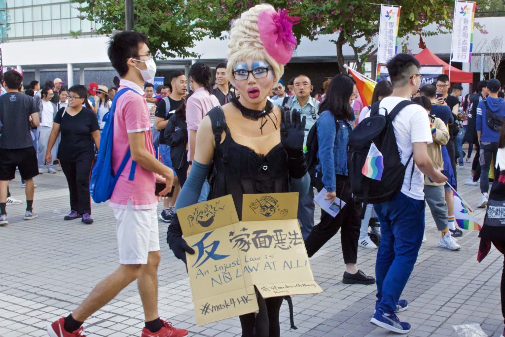 Person in drag holding an anti-mask law placard at Hong Kong Pride 2019. Photo by Vicky Wong.