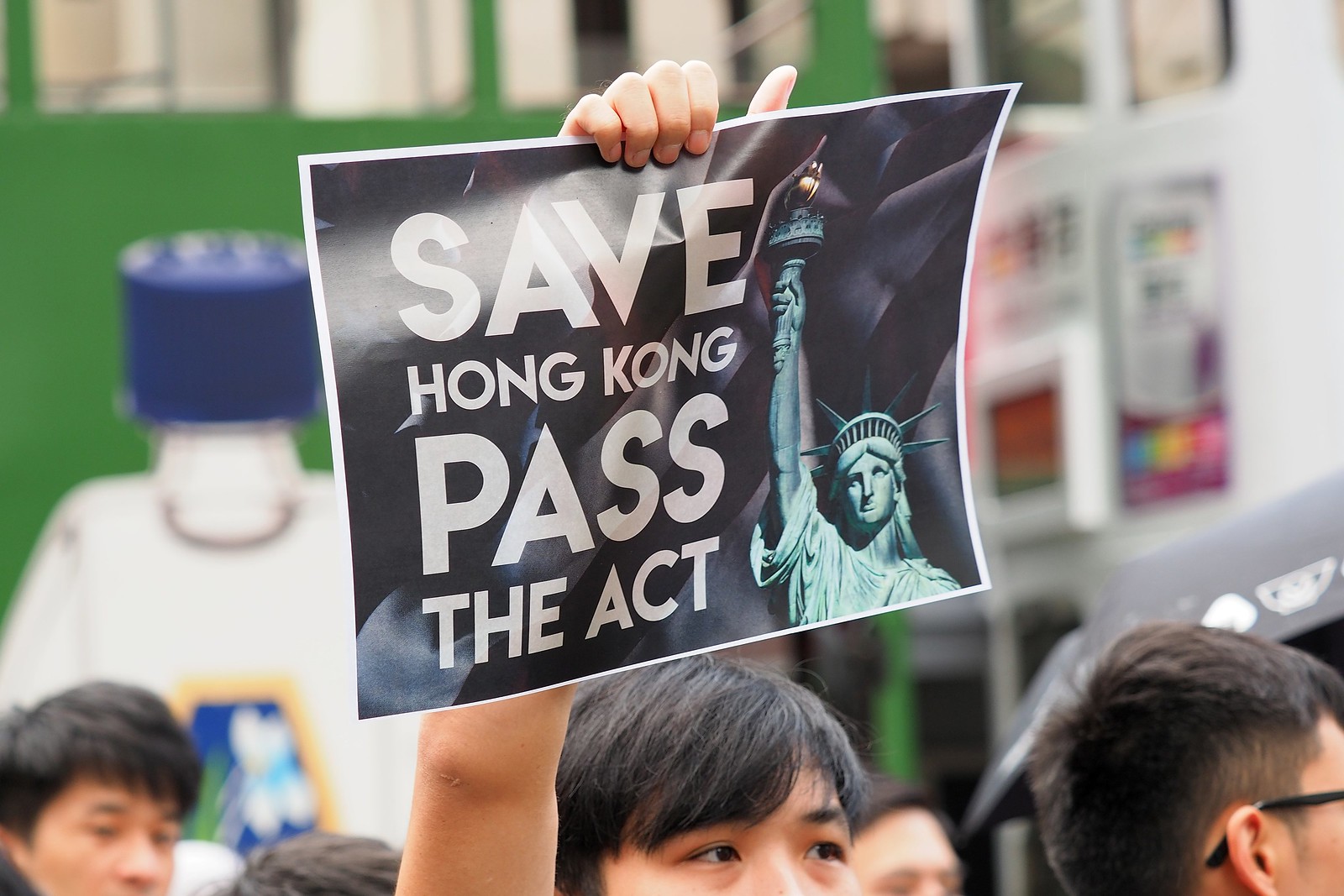 A protester holds up a sign calling on the U.S. to pass the Hong Kong Human Rights and Democracy Act during a rally in September. Photo via Flickr/Etan Liam.