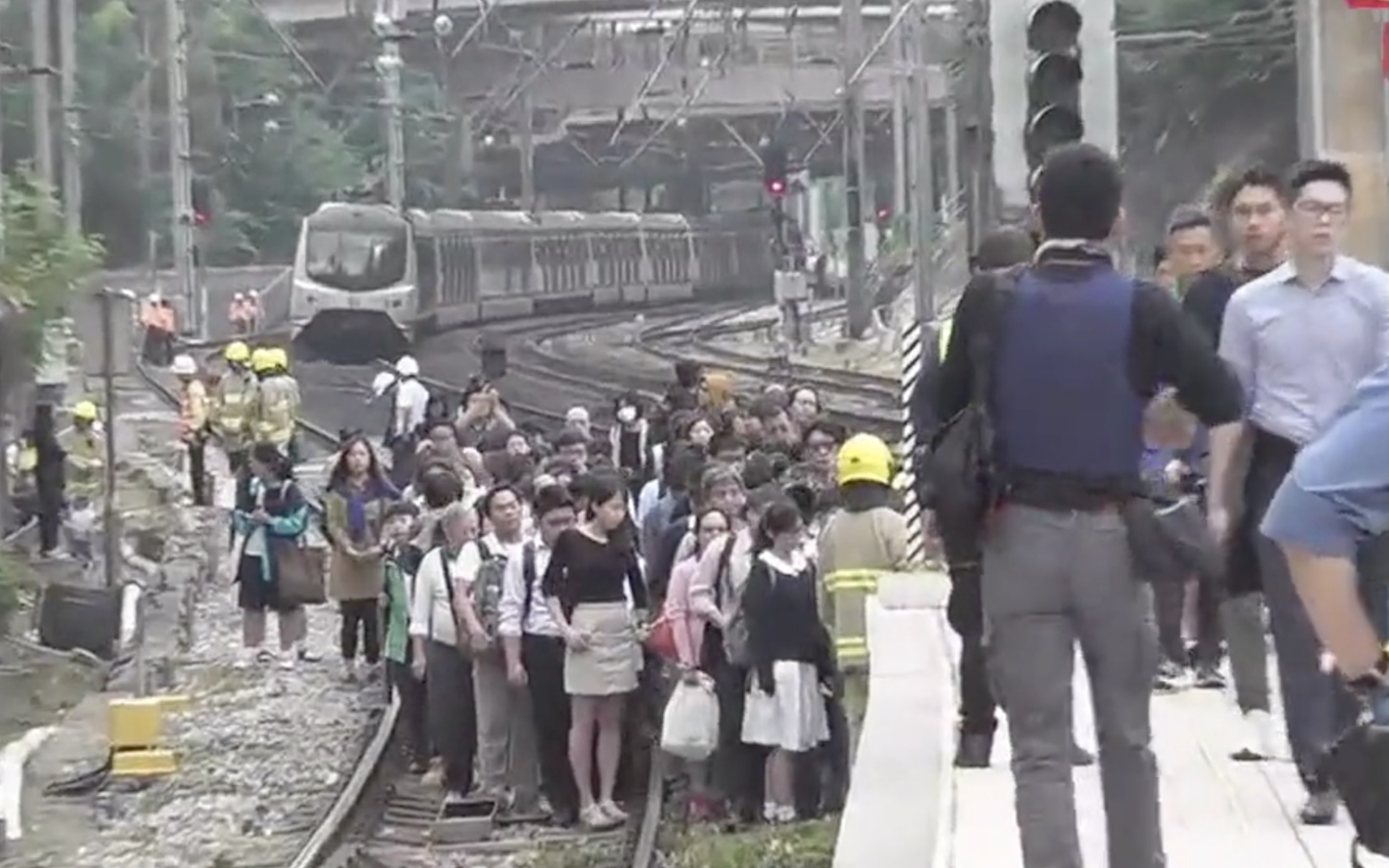 Passengers on board an East Rail Line train had to walk to Sha Tin station after protesters had thrown debris onto the tracks. Screengrab via Facebook video/HK01.