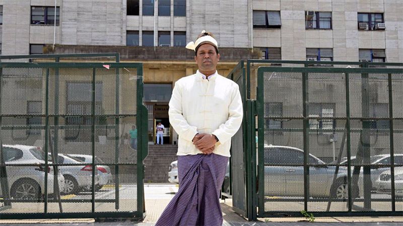 Tun Khin, president of The Burmese Rohingya Organisation UK, stands Wednesday in front of the Argentine federal court in Buenos Aires. Photo: Juan Mabromata / AFP