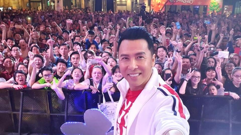 Hong Kong actor Donnie Yen poses for a selfie with fans in Tampines. Photo: Our Tampines Hub/Facebook