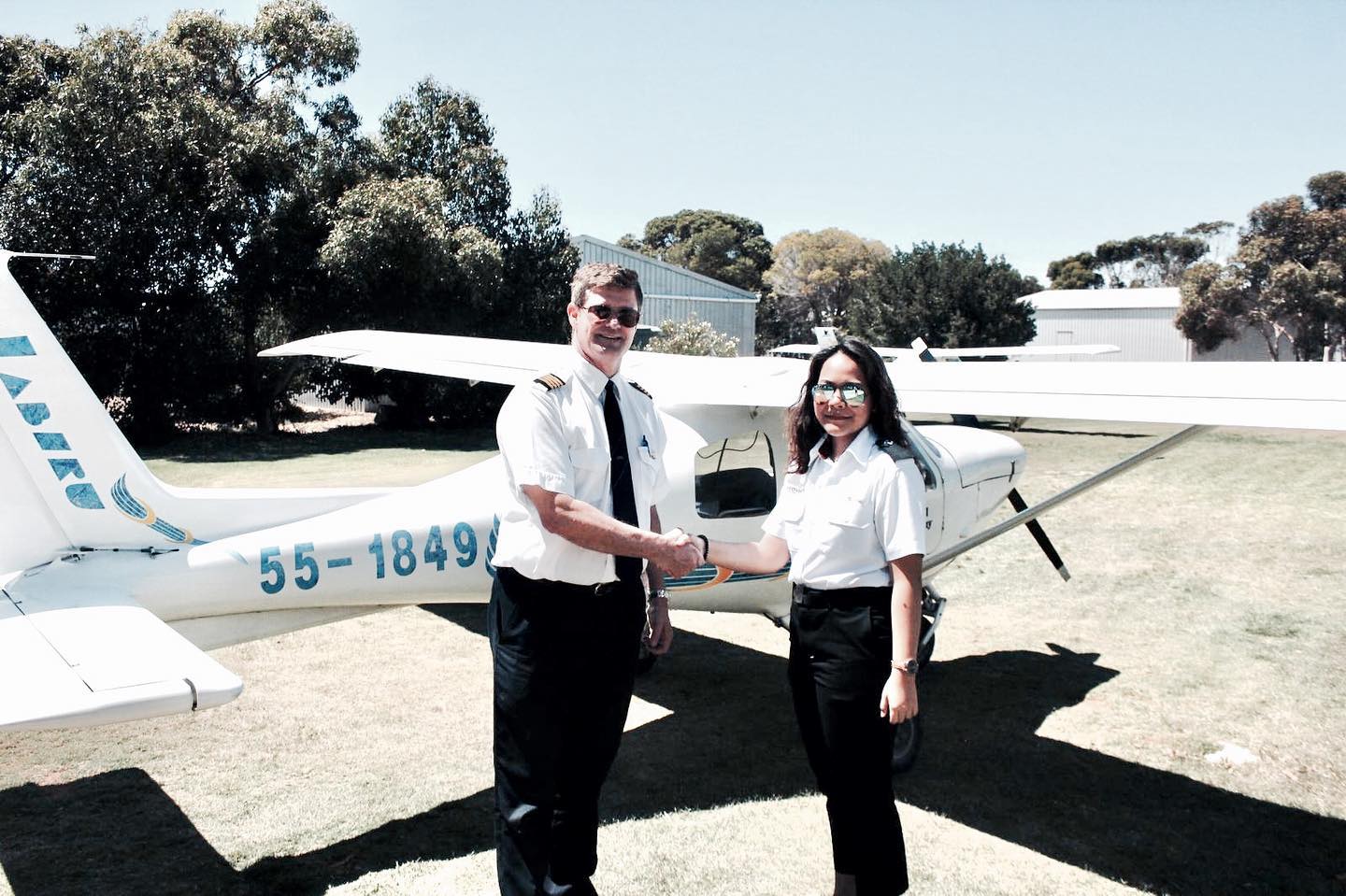 Haazeqah Shah shakes hands with an aviation instructor in Australia. Photo: Aeroviation Singapore/Facebook