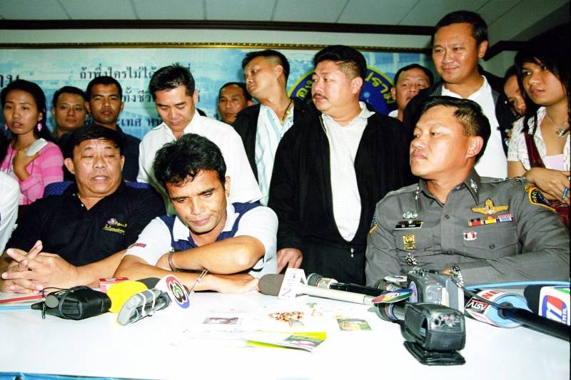 Somkid Pumpuang, front center, upon his arrest in 2005.