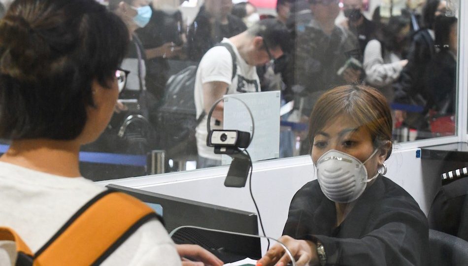 Workers in Ninoy Aquino International Airport in Manila wear protective masks as precaution from the coronavirus from Wuhan, China <i></noscript>Photo: Mark Demayo / ABS-CBN News</i>