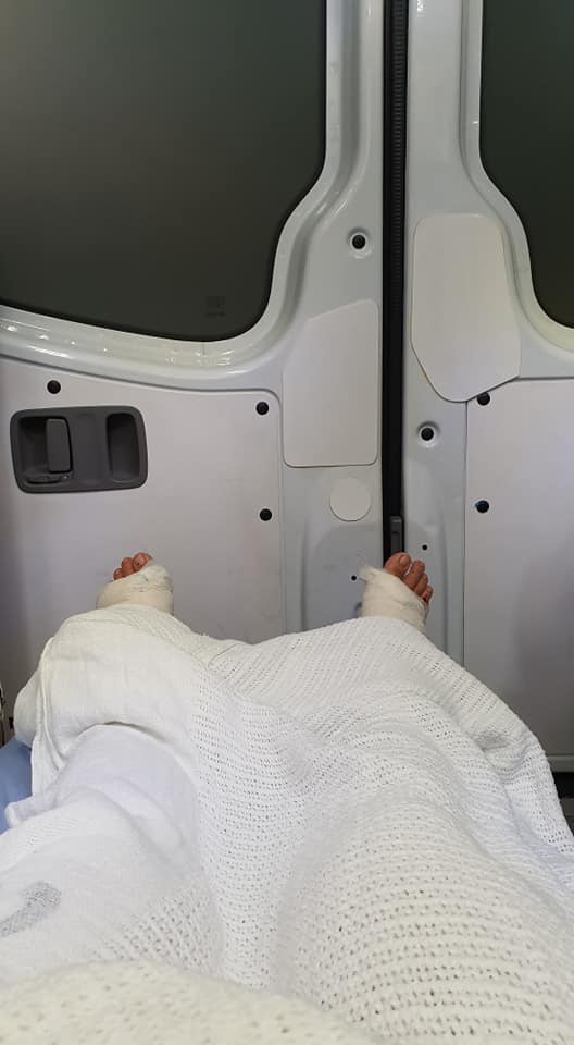 View of bandaged legs inside an ambulance. Photo: Stephanie Chu/Facebook