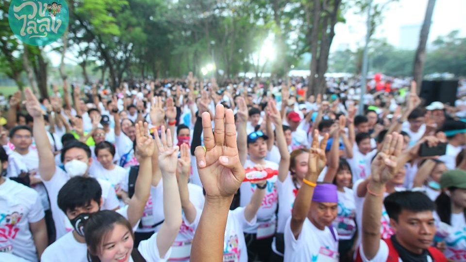 Runners raise three fingers in a trademark gesture by those opposed to military rule on Jan. 12 at Suan Rot Fai, where the first edition of Run Against Dictatorship took place. Photo: Run Against Dictatorship / FB
