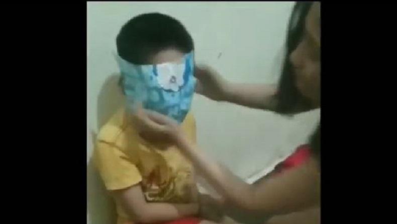 Screenshot from a viral video showing a domestic worker physically abusing her employer’s small child.