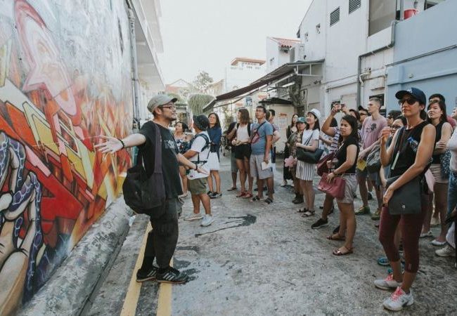 Visitors take in graffiti in the Kampong Glam neighborhood. Photo: D'Tour of Kampong Glam / Aliwal Arts Centre 