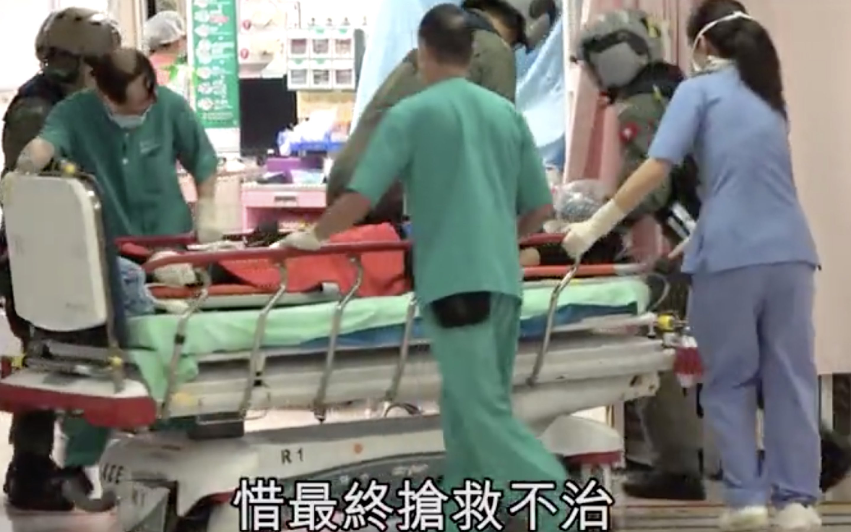 Emergency services staff try to resuscitate a 42-year-old female hiker who slipped and fell 15 meters during a hike on Lantau Peak. Screengran via Apple Daily video.
