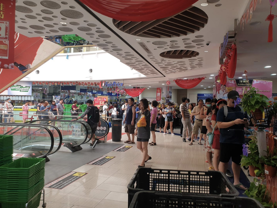 People queue for masks outside a NTUC Fairprice in Simei. Photo: Cindy Wong/Facebook