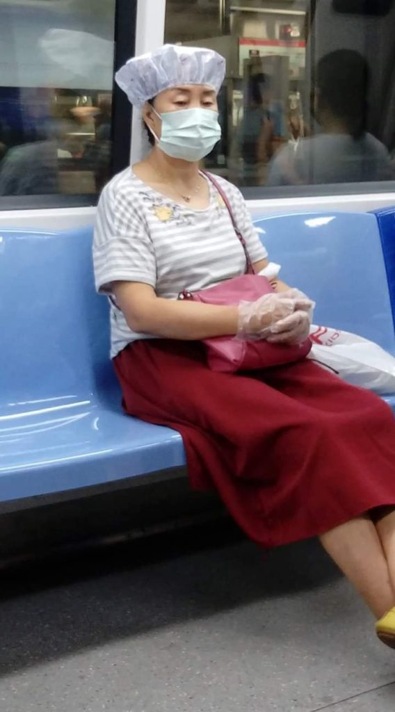 Woman dons shampoo hat onboard Singapore train. Photo: Justin Lim/Facebook