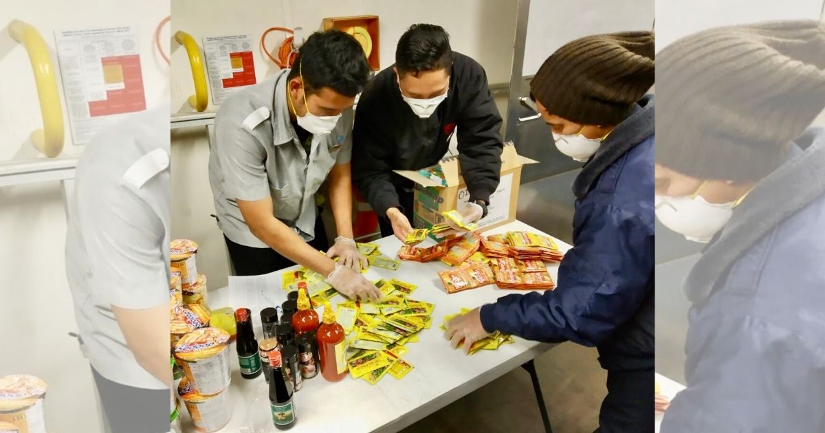 Representatives of 78 Indonesian crew members quarantined on the Diamond Princess cruise ship  anchored off the Port of Yokohama are seen sorting through the contents of the care package sent by The Indonesian Embassy in Tokyo (KBRI Tokyo). Photo: Twitter/@KBRITokyo