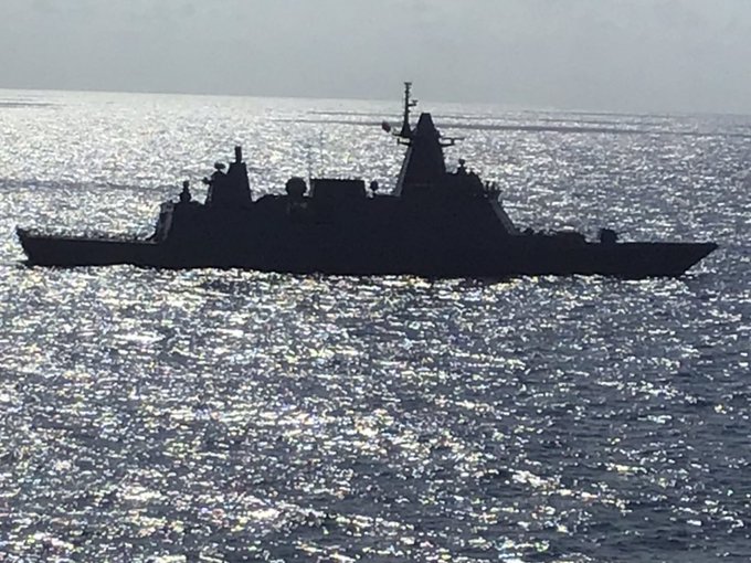 An image of the HTMS Bhumibol Adulyadej frigate escorting the cruise ship taken by a passenger. Photo: @Pebblecovefarm / Twitter
