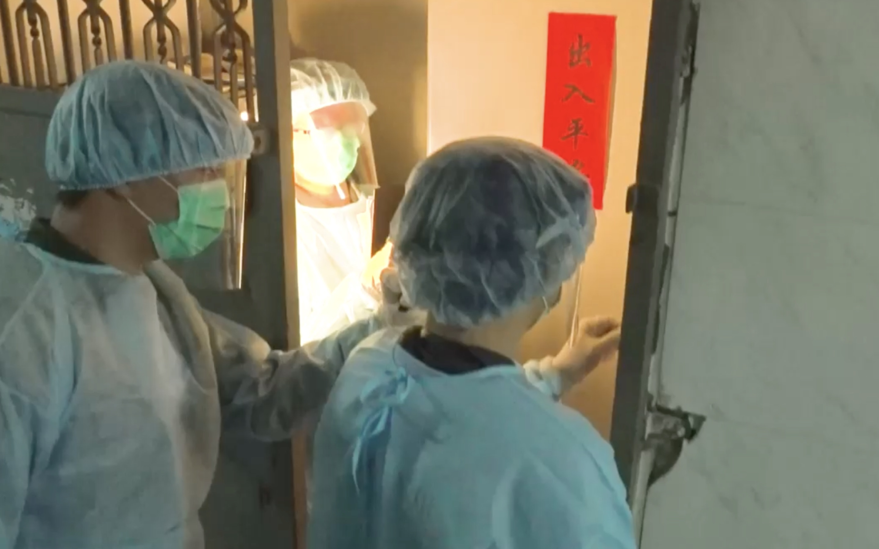 Centre for Health Protection personnel taking samples at a party room in Kwun Tong after 10 out of 19 people who went to a hot pot party in the room tested positive for the coronavirus. Screengrab via Facebook video/RTHK.
