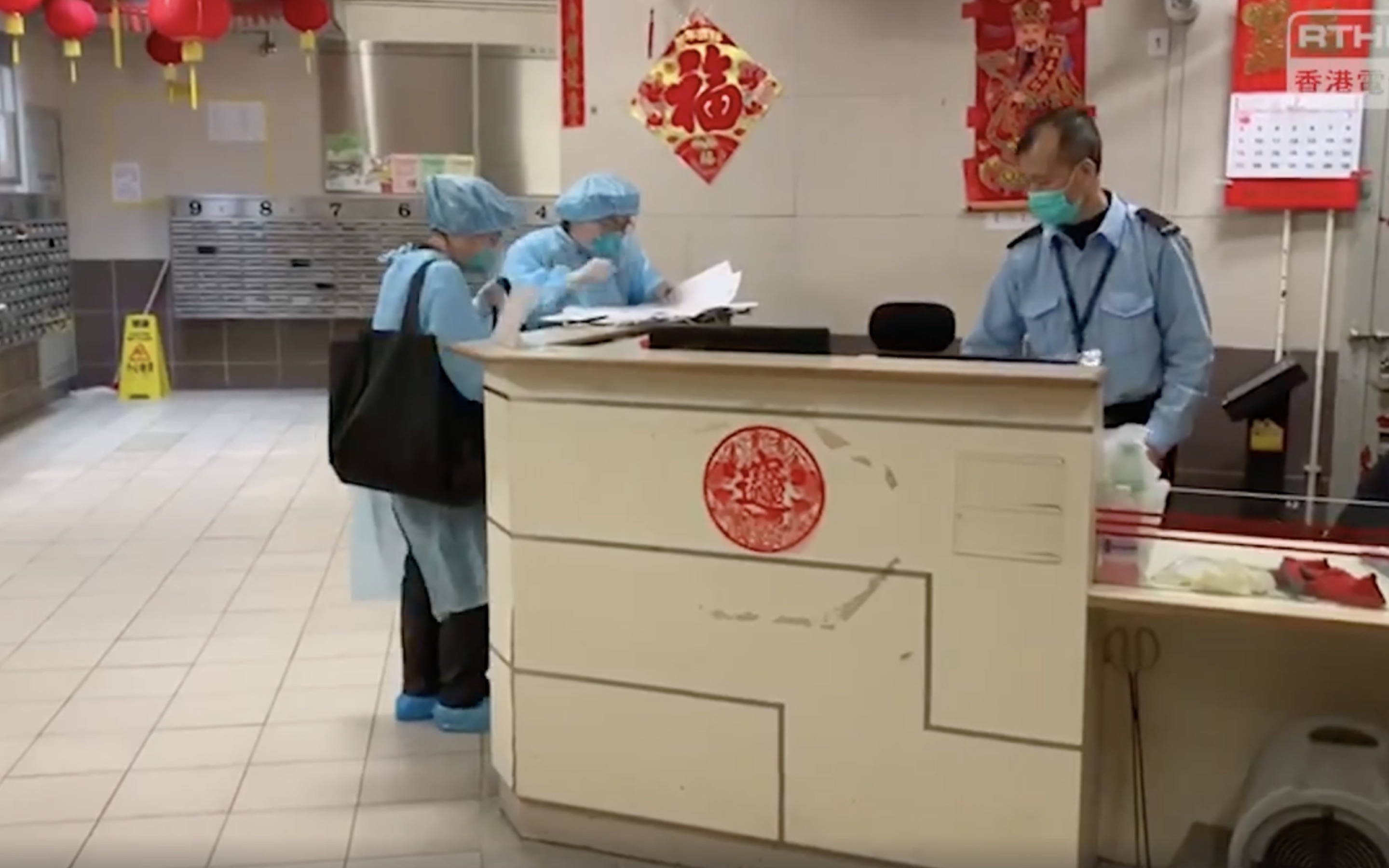 Centre for Health Protection personnel at Hong Mei House in Tsing Yi. Screengrab via Facebook/RTHK.