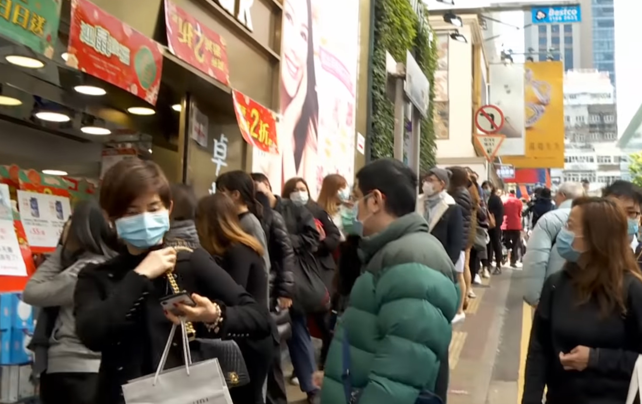 People line up outside a pharmacy in Hong Kong in February in hopes of buying face masks amid a citywide shortage. Screengrab via YouTube.