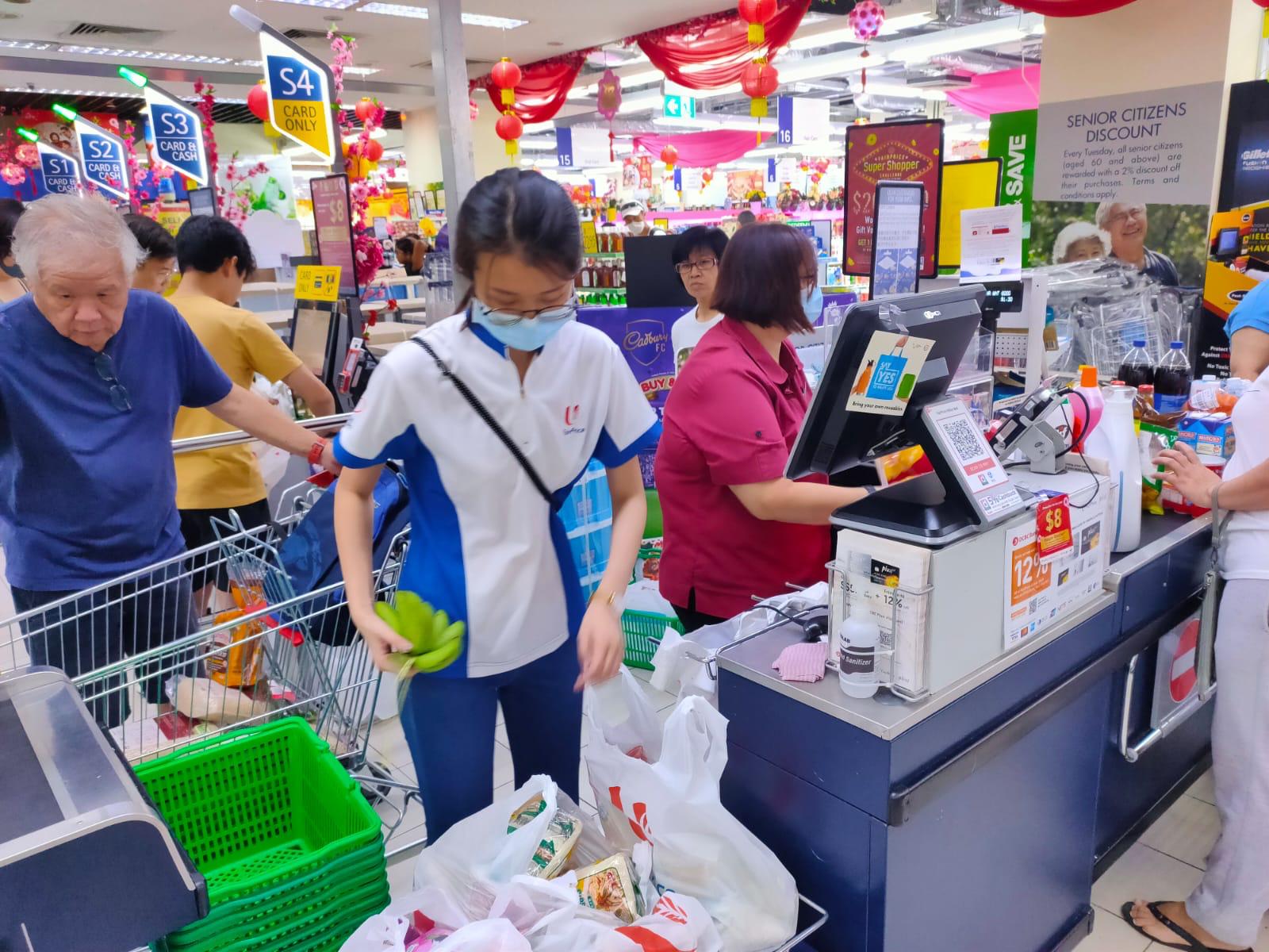 Shoppers paying for their groceries at an NTUC Fairprice supermarket outlet in a photo dated Feb. 10. Photo: NTUC Fairprice/Facebook