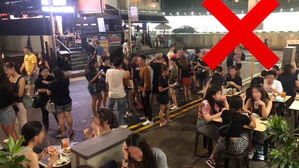 People gathering in groups of more than 10 and without a 1-meter distance from each other in a crossed out photo dated March 23. Photo: Enterprise Singapore