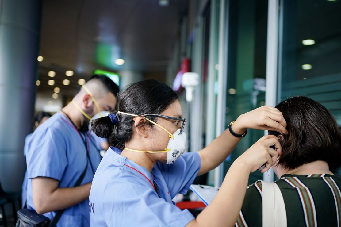 Temperature checks conducted at a hospital in Singapore in a file photo. Photo: Jurong Health Campus/Facebook