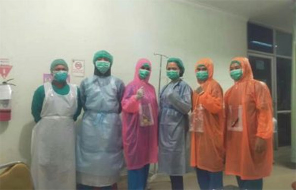 Healthcare workers at a community clinic in Bogor regency, Indonesia wearing single-use plastic raincoats in the absence of protective medical gear. Photo: Istimewa