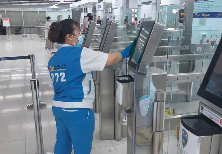 Staff disinfect a passport scanner at Bangkok’s Suvarnabhumi Airport. Photo: Suvarnabhumi Airport
