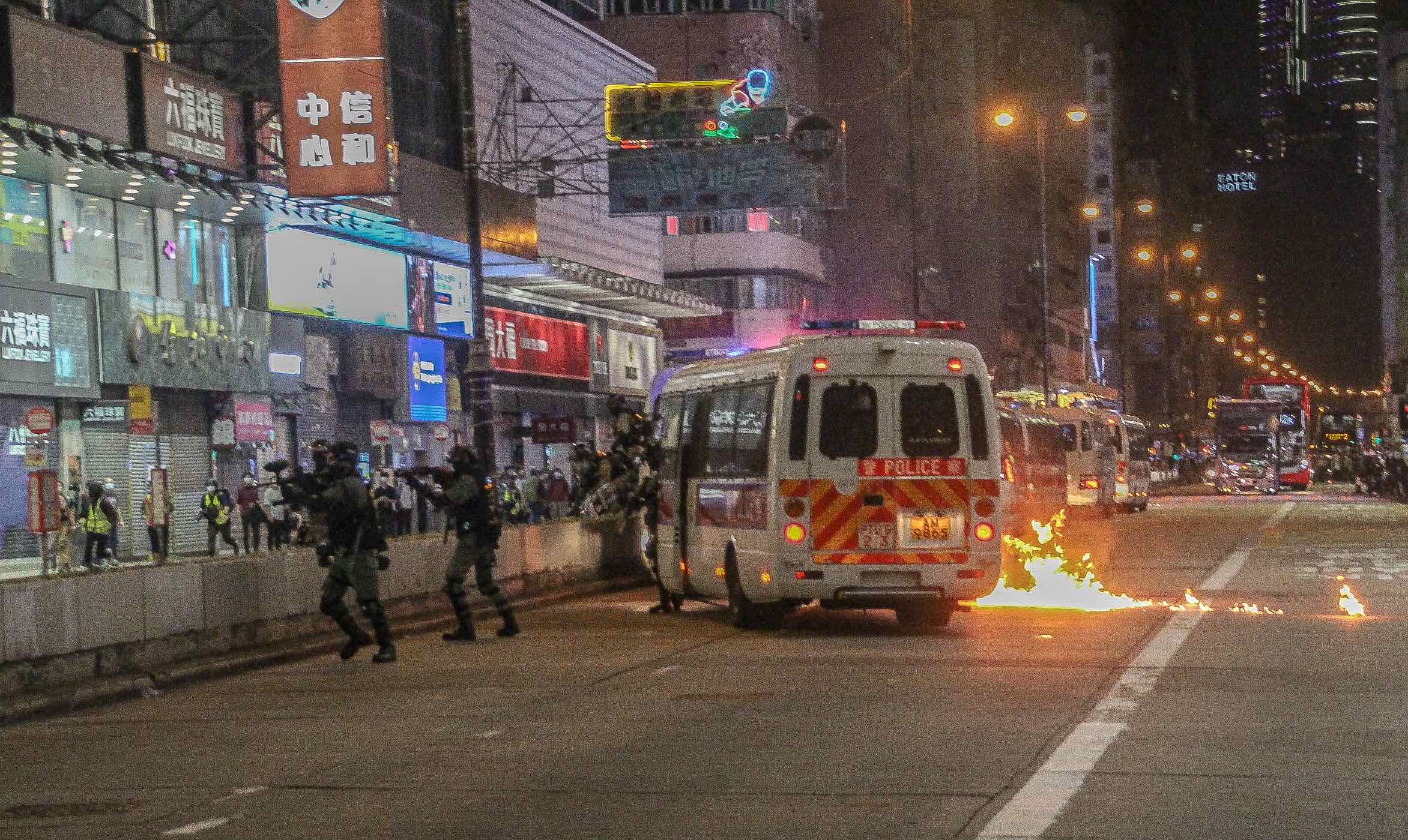 A fire burns near a police van during protests in Mong Kok on Feb. 29, 2020. Photo: Tommy Walker