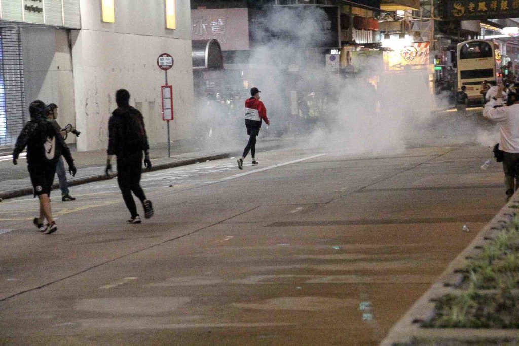 Tear gas is deployed during clashes between police and protesters in Mong Kok on Saturday. Photo by Tommy Walker.