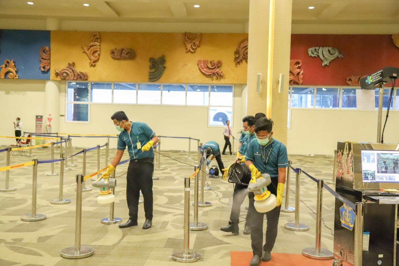 File photo of staff spraying disinfectant at the Ngurah Rai International Airport. Photo: Ngurah Rai International Airport