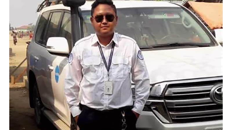 Pyae Sone Win Maung poses with his U.N.-marked vehicle in an undated photo.
